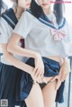 two asian girls in school uniforms posing for the camera