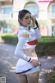 A woman in a white and red outfit posing for a picture.