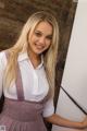 A young woman in a school uniform posing for a picture.