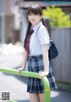 A young woman in a school uniform is posing for a picture.