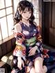 A woman in a kimono sitting on a window sill.