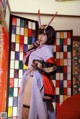 A woman in a kimono is posing for a picture.