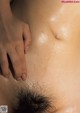 A close up of a woman's stomach with her hand on her stomach.